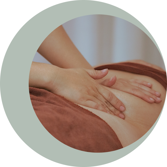 Hands massaging a person's back gently.