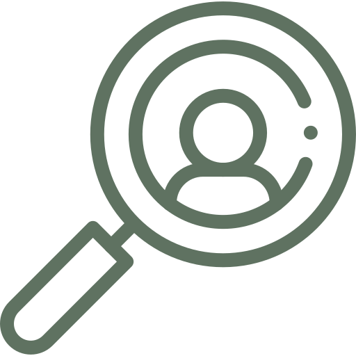 Magnifying glass focusing on a target symbol on a green background.